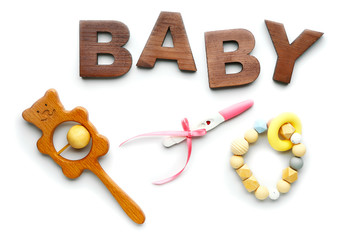 Pregnancy test, word BABY and toys on white background