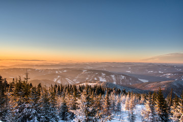 Winter landscape with a mountain forest. Sunset in the mountain valley.  czech beskydy
