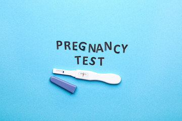 Pregnancy test on color background