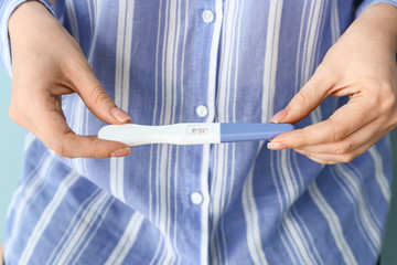 Young woman with pregnancy test, closeup