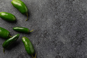 Fresh Picked Jalapeno Peppers on dark concrete background