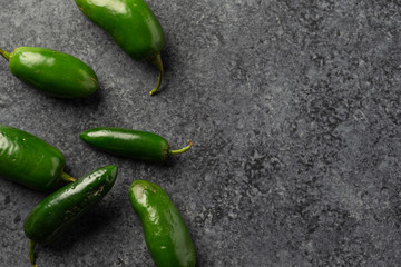 Fresh Picked Jalapeno Peppers on dark concrete background