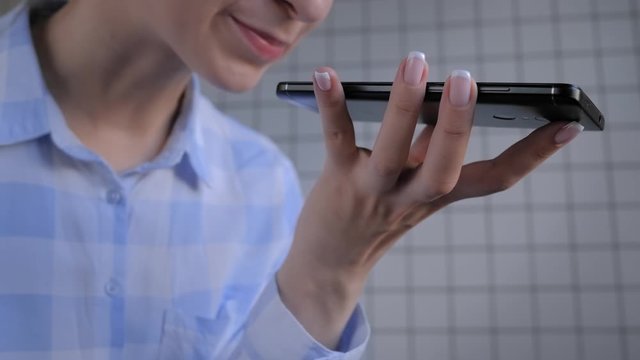 Slow motion: woman holding smartphone device, using voice recognition function, recording audio message or talking with mobile assistant. Authentication, communication, online technology concept