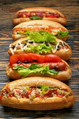 Tasty hot dogs on wooden background