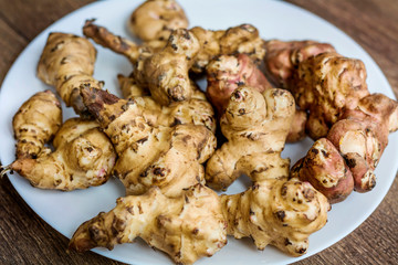 Yacon Ground Apple in a Plate on a Wooden Background 