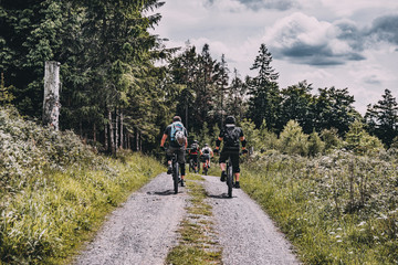 Obraz premium cyclists on the road, mountainbiking in forest