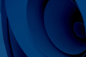 Blue abstract background of swirling material. Several planes twisted into a roll.