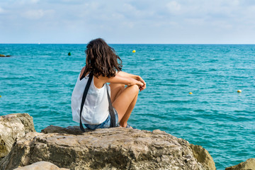 Young Woman Standing Alone and Looking  the Sea 