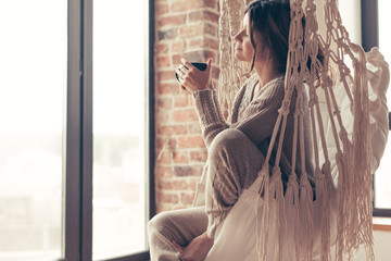 Woman wearing cashmere nightwear relaxing in cabin