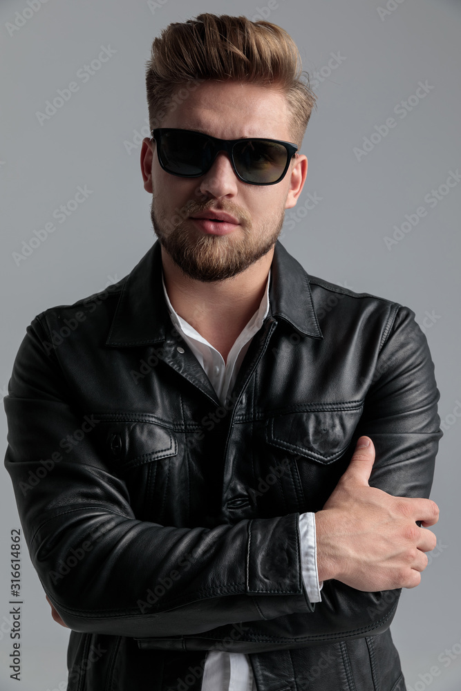 Wall mural sexy young model wearing leather jacket and sunglasses