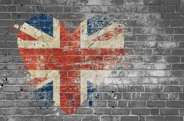 Heart shaped flag of Britain painted on brick wall