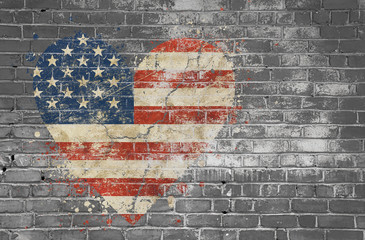 Heart shaped flag of USA painted on brick wall