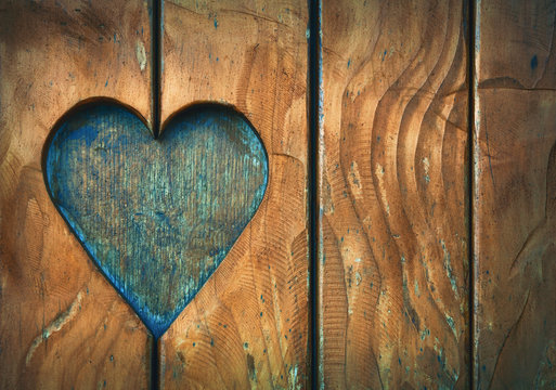 One heart shape carved in vintage wood close up
