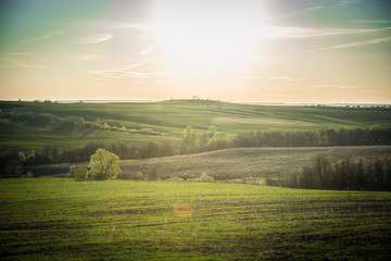 Fototapeta na wymiar fields and hills in the setting sun