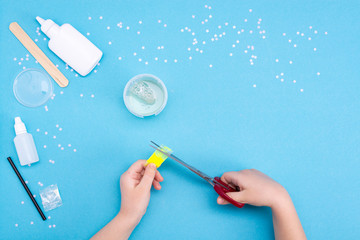 How to make mucus at home. Children's art project. DIY concept. Children's hands making slime toy...