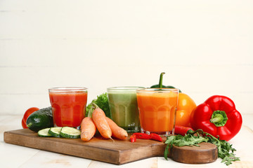 Glasses of fresh vegetable juices on table