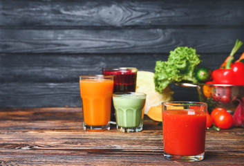 Glass of fresh vegetable juice on table