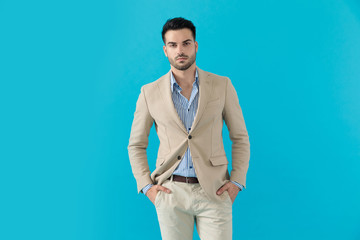 dramatic young man holding hands in pockets