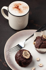 Tasty homemade chocolate muffin with banana. Chocolate cake with coffee.