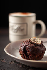 Tasty homemade chocolate muffin with banana. Chocolate cake with coffee.