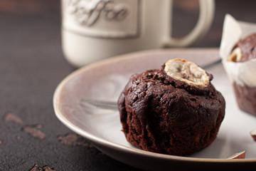 Tasty homemade chocolate muffin with banana. Chocolate cake with coffee.