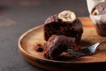Tasty homemade muffin braking by fork. Tasty muffin with coffee close-up.