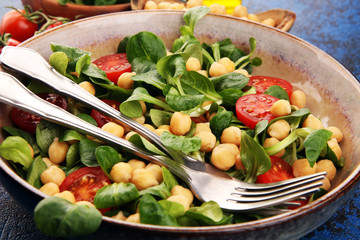 chickpea salad with ingredient and tomatoes and lamb´s lettuce. healthy salad