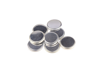 Heap of lithium button cell batteries. Closeup. Isolated on white background.