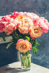Fresh bunch of pink peonies and roses in the vase. Card Concept, pastel colors, grey background