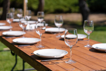Served wooden table without a tablecloth. Cafe in the open air park