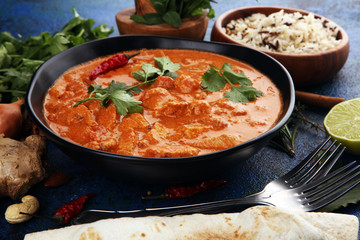 Chicken tikka masala spicy curry meat food in pot with rice and naan bread. indian food