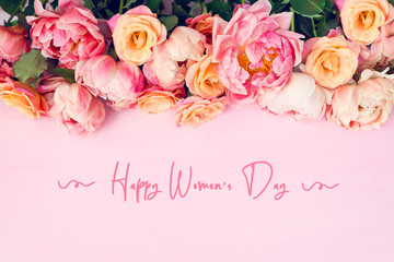 Fresh bunch of pink peonies and roses and text Happy Womens Day. Card Concept, pastel colors, close...