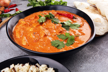 Chicken tikka masala spicy curry meat food in pot with rice and naan bread. indian food