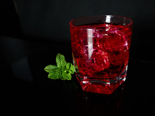 Strawberry, mint, ice, drink on a black background