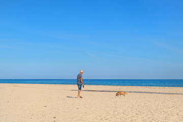 Fototapeta na wymiar Corsica beach landscape with man and dog