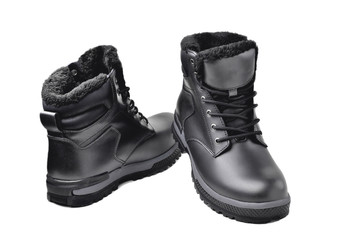 Winter men’s black leather boots on a white background, hiking shoes, practical off-road shoes, close-up