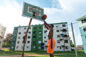 Young African American Man Playing Basketball On Outdoor Court in Cuba