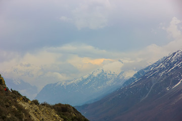 Fototapeta premium Nepal snowy mountains against the blue sky with clouds