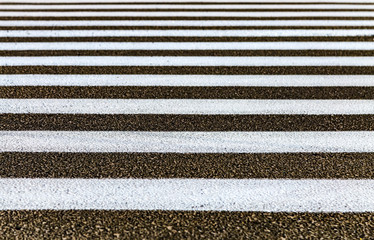 Fototapeta premium Closeup zebra pedestrian crossing on the asphalt road. White stripes on black road.