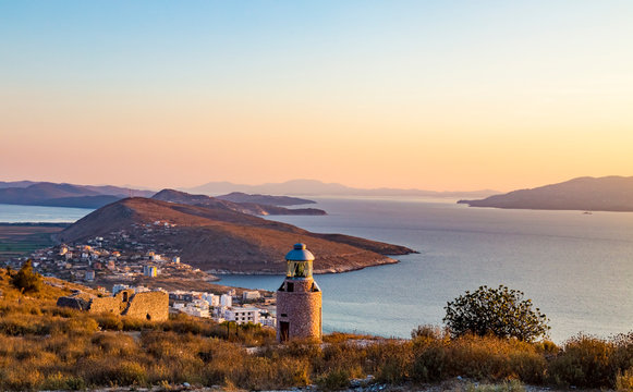 Beautiful sunset view from Lekuresi Castle (Saranda, Albania) to Ionian sea, small functioning lighthouse and island Corfu, Greece in the background