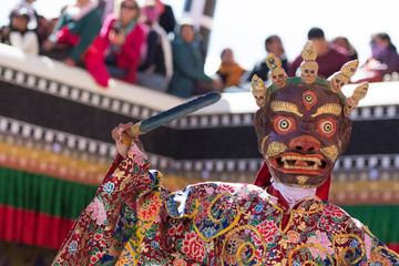 Creature dancing with a sword in Gustor mask festival in Ladakh, India