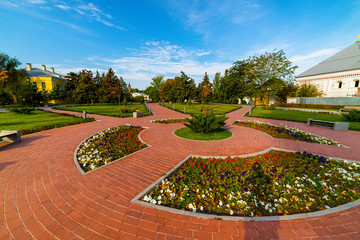 Flowerbeds, Grass Pathway and Ornamental Vase in a Formal Garden