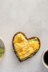 heart shaped healthy avocado toast with scrambled egg