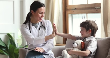 Happy child boy patient and female pediatrician giving high five - Powered by Adobe