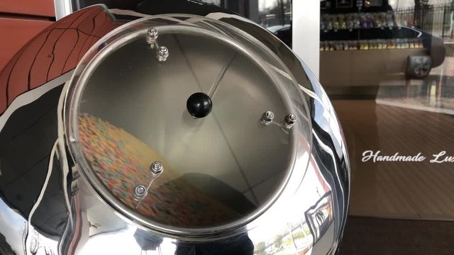 There are chocolate chips that look like pebble in the big cauldron and it turn clockwise