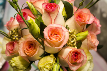 A festive bouquet of roses of yellow and pink flowers with edging on the petals