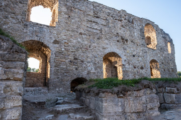 Old stone wall with windows, ruins of an ancient castle