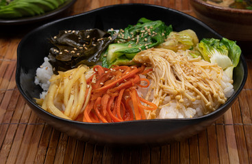 Chirashizushi and miso served in black bowl