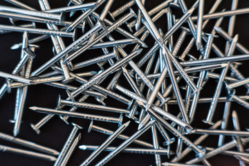 metal construction nails close-up on black background