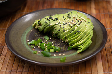 Sliced avocado and sesame seeds